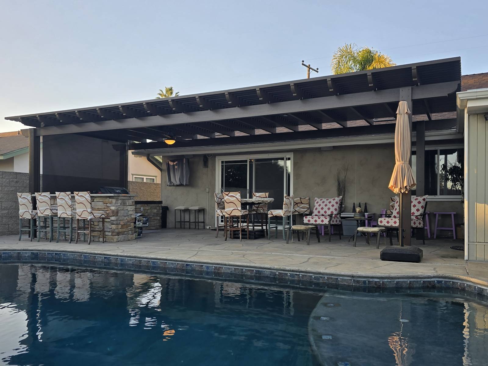 Poolside Spanish brown freestanding aluminum lattice pergola in Clairemont California