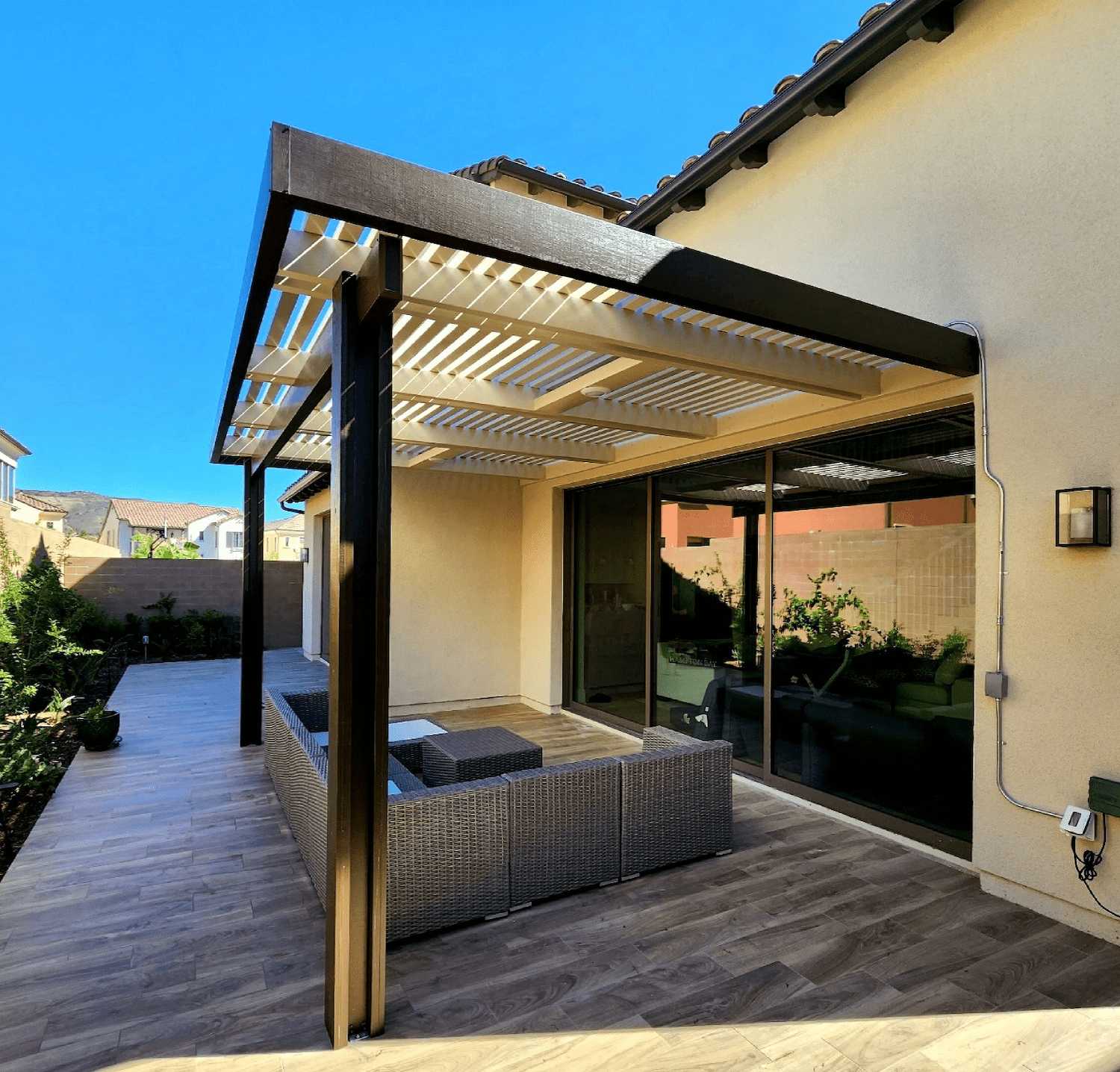 Spanish brown aluminum lattice pergola attached to a home